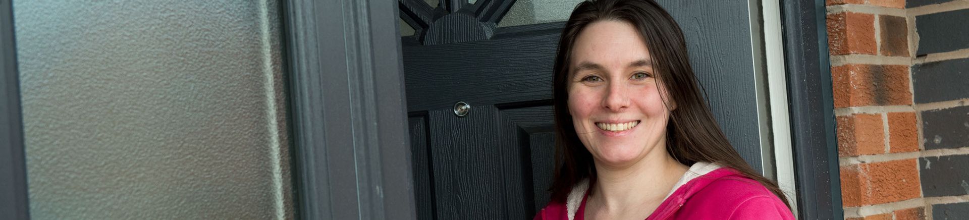 image of woman in front of home door